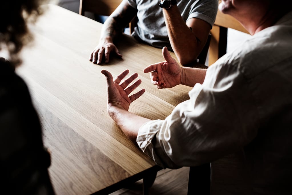 A group of people sat around arguing about contesting wills.