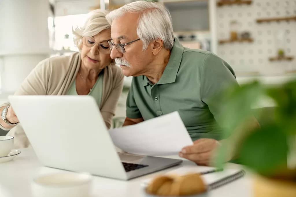 An old couple looking over their documents.