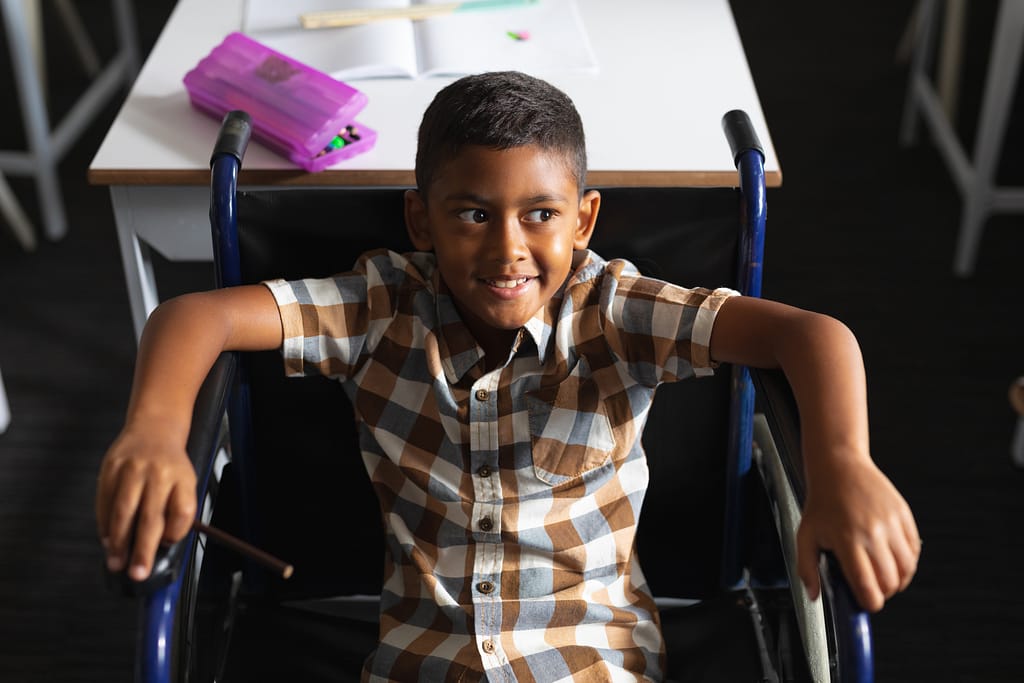 A young child in a wheelchair. For the vulnerable person's trust blog.